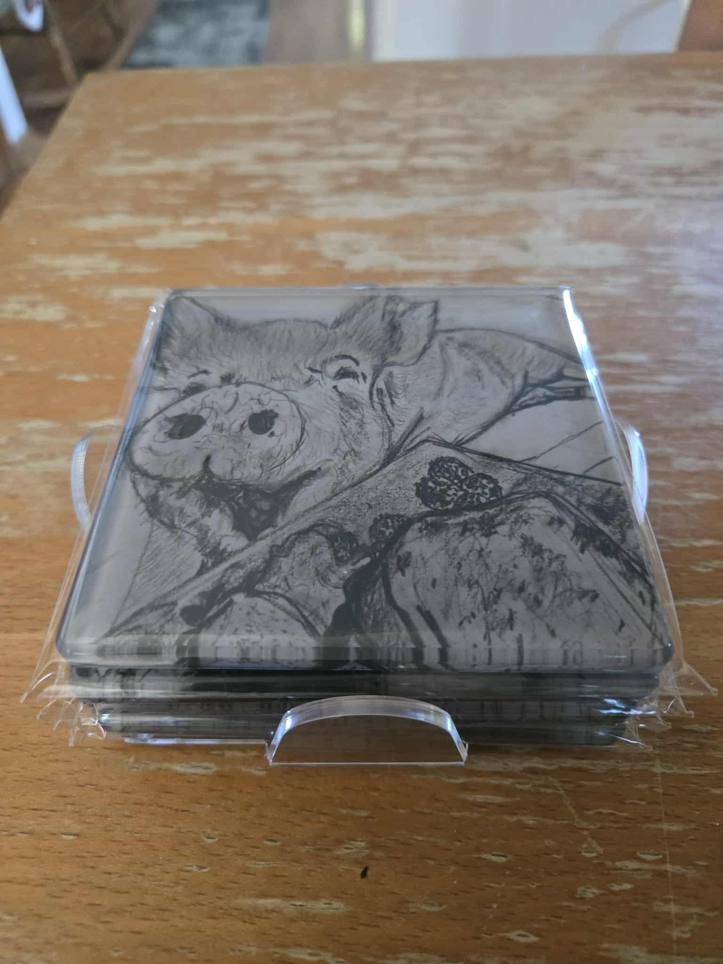 Set of 4 coasters featuring our favorite pigs and one energetic dog.