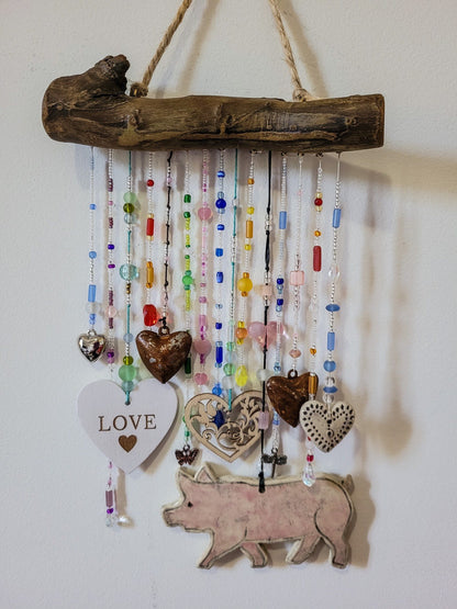 Handcrafted wall hanging with pig, hearts and beads