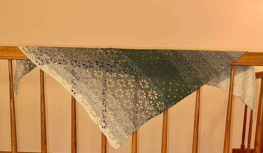 Crocheted shawl from acrylic yarn in green tones with lots of sparkle.